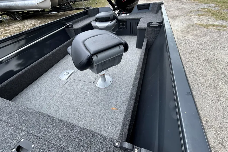 Slide: The Image of 2026 Crestliner 1650 Discovery Tiller boat interior with seating and carpeted flooring. - 7