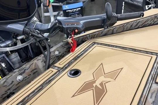 Slide: The Image of 2026 Xpress X18DB boat interior with steering controls and logo detail. - 4