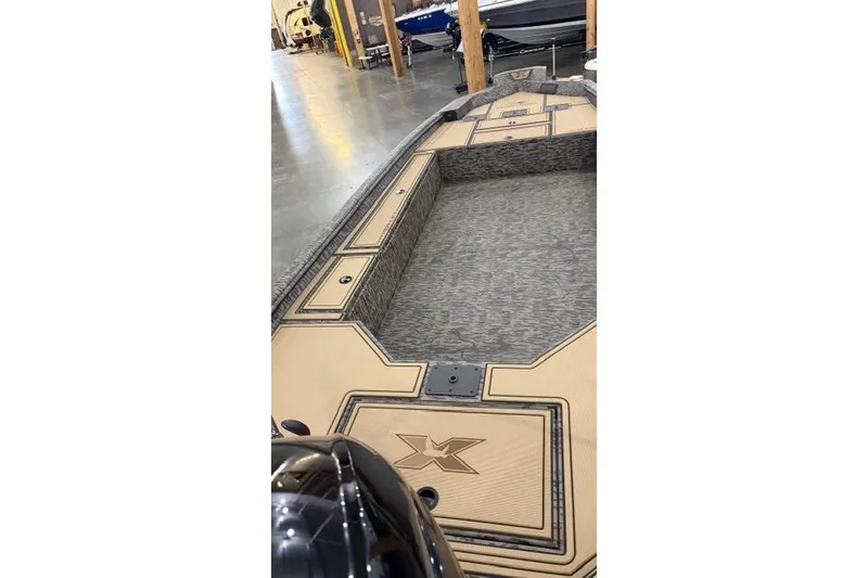 Slide: The Image of 2026 Xpress X18DB boat interior with spacious deck and storage compartments. - 6