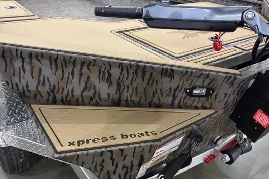 Slide: The Image of 2026 Xpress X18DB boat with camouflage design and "xpress boats" branding. - 7