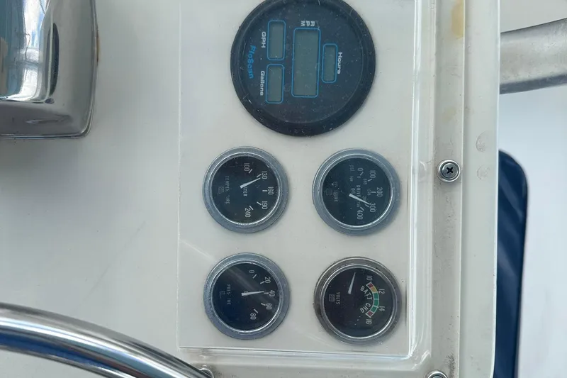 Slide: The Image of Dashboard gauges of a 1981 Hatteras 43 Convertible boat, displaying various engine metrics. - 11
