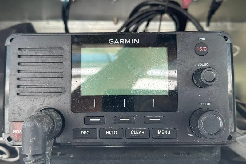 Slide: The Image of Garmin marine radio on 1981 Hatteras 43 Convertible boat dashboard. - 12