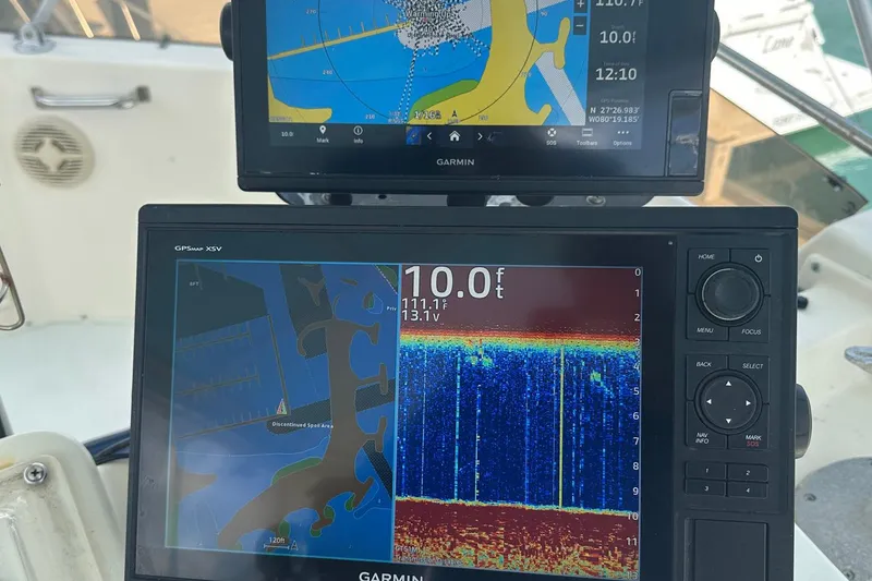 Slide: The Image of Garmin GPS displays on 1981 Hatteras 43 Convertible boat, showing navigation and sonar data. - 13
