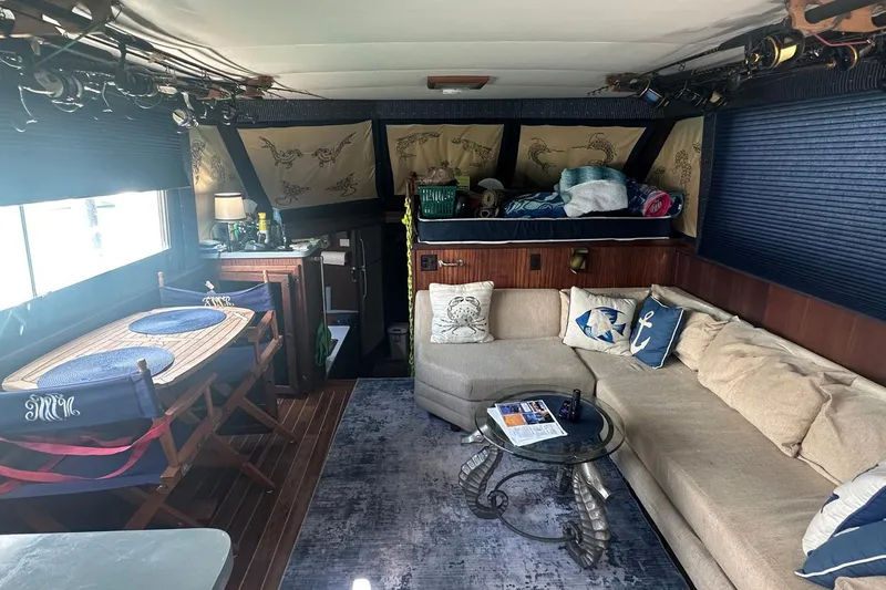 Slide: The Image of Interior of 1981 Hatteras 43 Convertible yacht with cozy seating and nautical decor. - 15