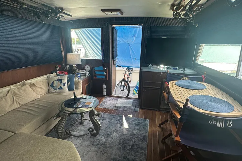 Slide: The Image of Interior of 1981 Hatteras 43 Convertible yacht with cozy seating and dining area. - 17