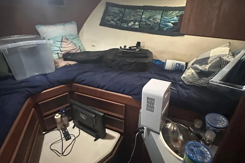 Slide: The Image of Interior cabin of 1981 Hatteras 43 Convertible with bed, storage, and personal items. - 22