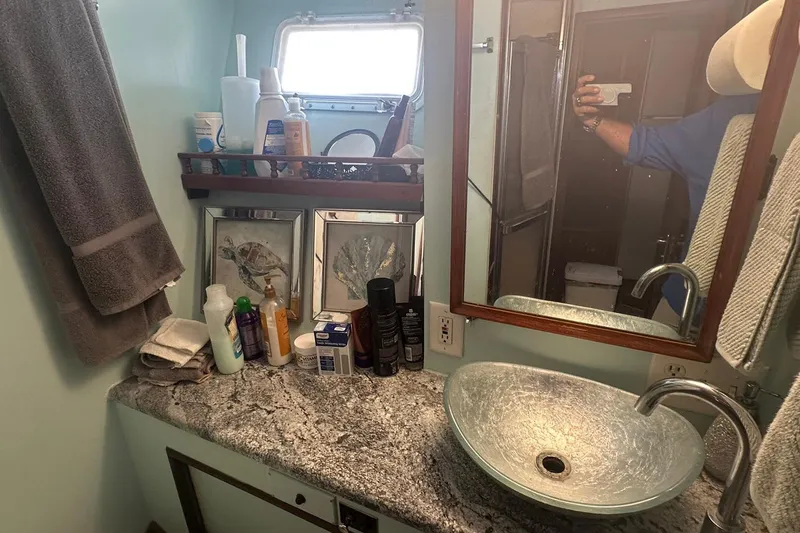 Slide: The Image of Bathroom interior of 1981 Hatteras 43 Convertible yacht with granite countertop and vessel sink. - 24