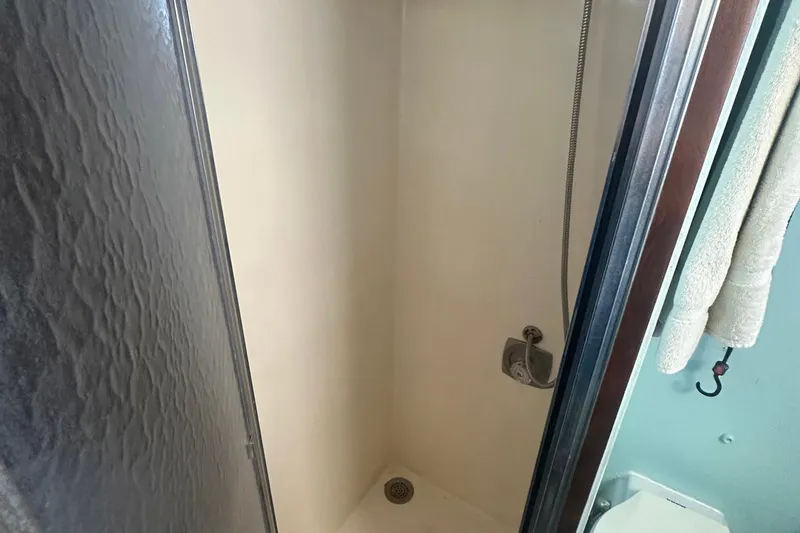 Slide: The Image of Shower area inside 1981 Hatteras 43 Convertible yacht, featuring a sleek design. - 25