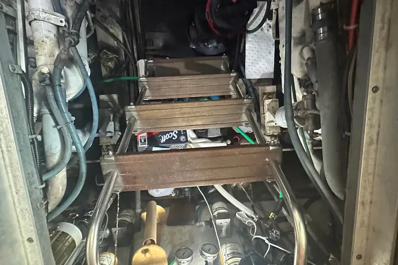 Slide: The Image of Engine room of a 1981 Hatteras 43 Convertible boat with visible machinery and pipes. - 26