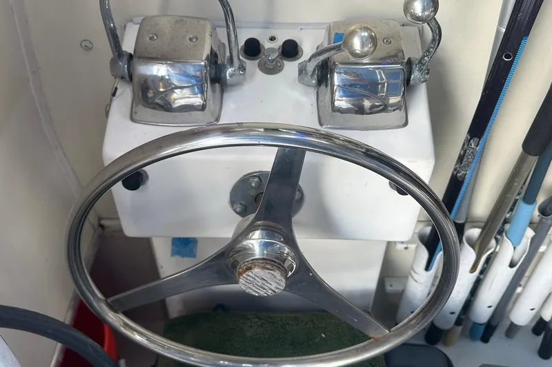 Slide: The Image of Steering wheel and controls of a 1981 Hatteras 43 Convertible boat. - 6