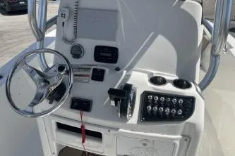 Slide: The Image of 2023 NauticStar 2302 Legacy boat console with steering wheel and control panel. - 11
