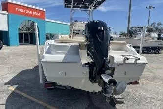Slide: The Image of 2023 NauticStar 2302 Legacy boat with outboard motor in a dealership lot. - 6