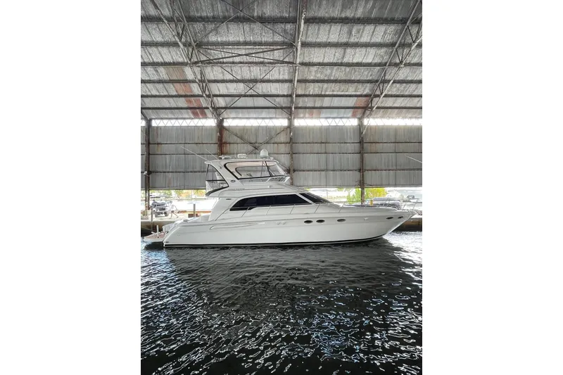 The Image of 2004 Sea Ray 480 Sedan Bridge yacht docked in a covered marina. - 1