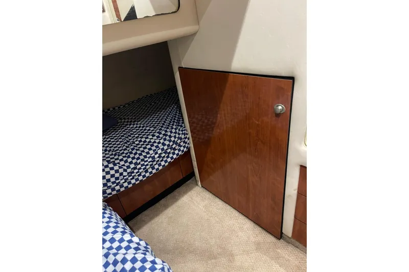 Slide: The Image of Interior cabin of 2004 Sea Ray 480 Sedan Bridge with checkered bedding. - 11