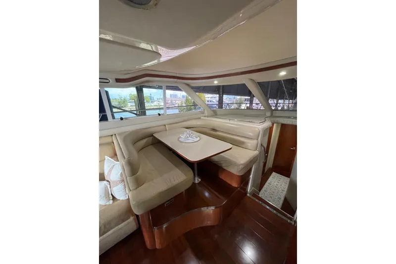 Slide: The Image of Luxurious interior of 2004 Sea Ray 480 Sedan Bridge yacht with elegant seating and dining area. - 12