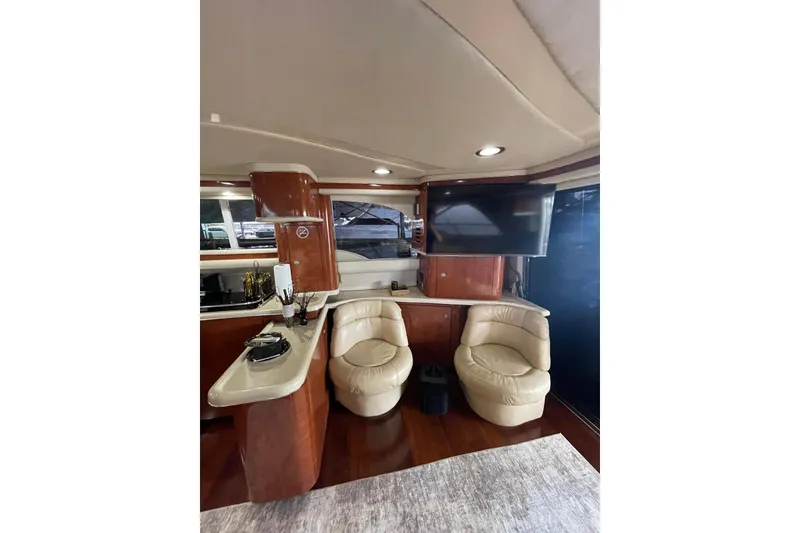 Slide: The Image of Luxurious interior of 2004 Sea Ray 480 Sedan Bridge yacht with leather seating and TV. - 14