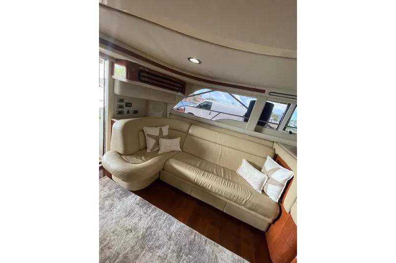 Slide: The Image of Luxurious interior of a 2004 Sea Ray 480 Sedan Bridge yacht with cream leather seating. - 16