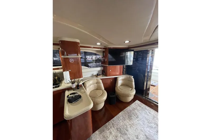 Slide: The Image of Luxurious interior of 2004 Sea Ray 480 Sedan Bridge yacht with leather seating and modern amenities. - 17
