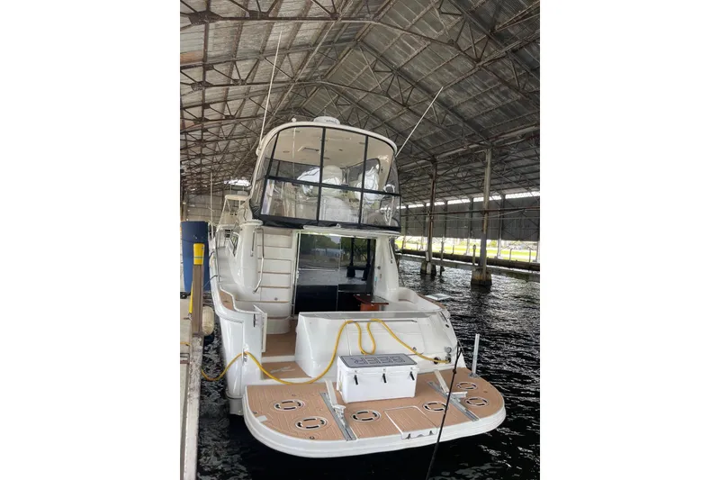 Slide: The Image of 2004 Sea Ray 480 Sedan Bridge yacht docked in a covered marina. - 4
