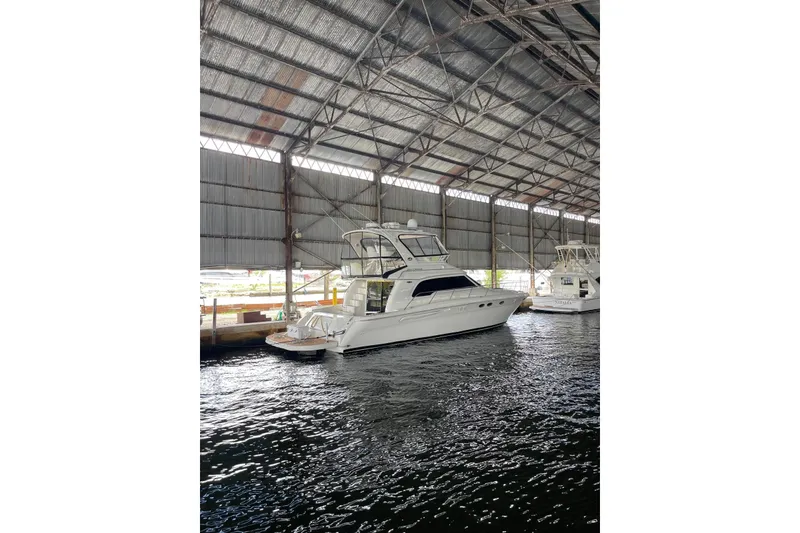 Slide: The Image of 2004 Sea Ray 480 Sedan Bridge yacht docked in a covered marina. - 5