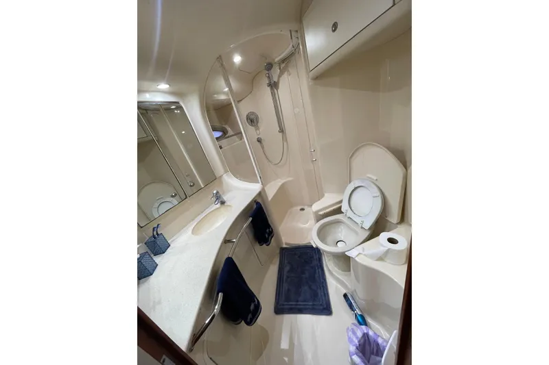 Slide: The Image of Luxurious bathroom in 2004 Sea Ray 480 Sedan Bridge yacht, featuring shower and vanity. - 9