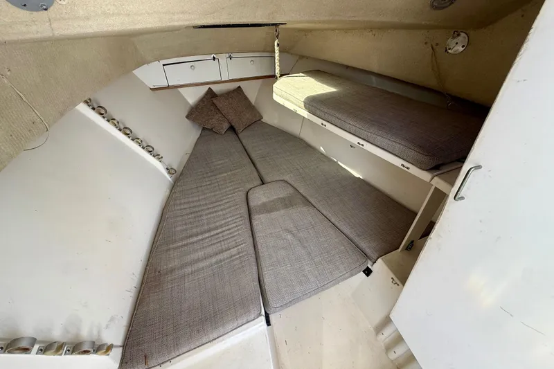 Slide: The Image of Interior cabin of a 1988 Negus 26 boat with cushioned seating and storage. - 13