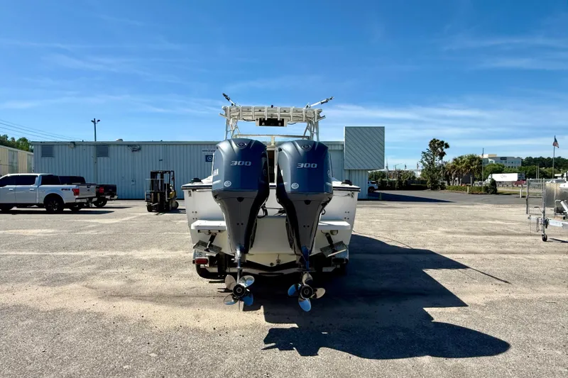 Slide: The Image of 1988 Negus 26 boat with dual 300 horsepower engines in a parking lot. - 3