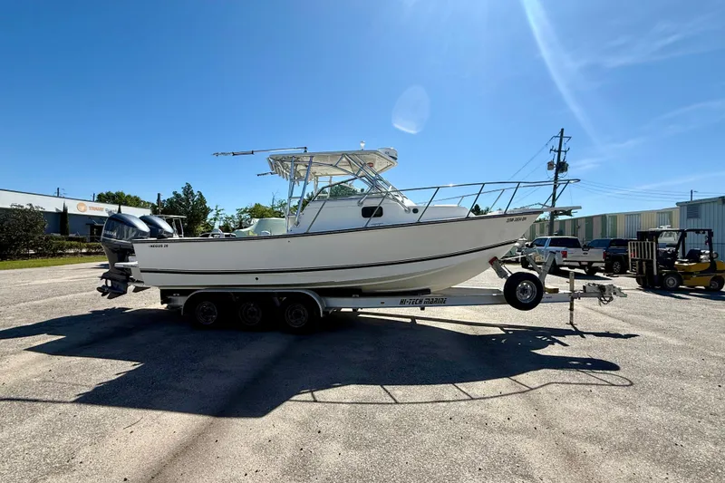 Slide: The Image of 1988 Negus 26 boat on trailer in sunny outdoor setting. - 5