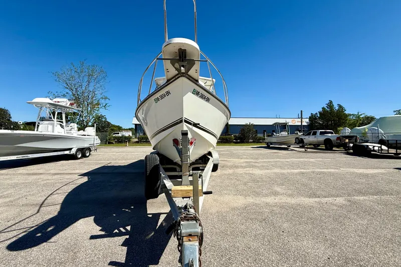 Slide: The Image of 1988 Negus 26 boat on trailer in sunny parking lot. - 7