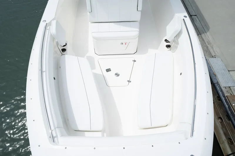 Slide: The Image of Manufacturer Provided Image: 2025 Pursuit S 268 Sport boat interior with white seating and storage compartments. - 7