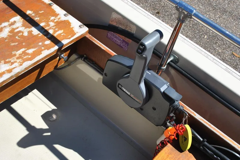 Slide: The Image of 1976 Boston Whaler 15 boat interior with Yamaha throttle control and wooden seating. - 14