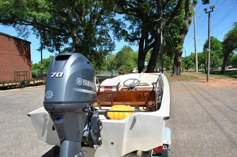 Slide: The Image of 1976 Boston Whaler 15 boat with Yamaha 70 outboard motor on a sunny day. - 16