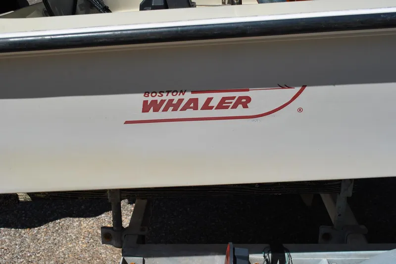 Slide: The Image of 1976 Boston Whaler 15 boat logo on hull, showcasing classic design. - 18