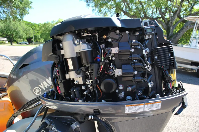 Slide: The Image of Open Yamaha outboard motor on a 1976 Boston Whaler 15, showcasing engine components. - 20