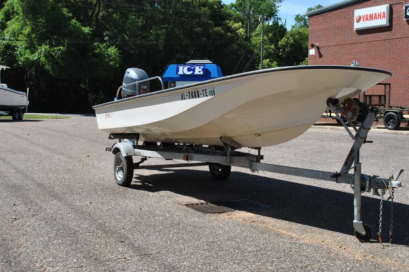 Slide: The Image of 1976 Boston Whaler 15 boat on trailer, parked near Yamaha building. - 4