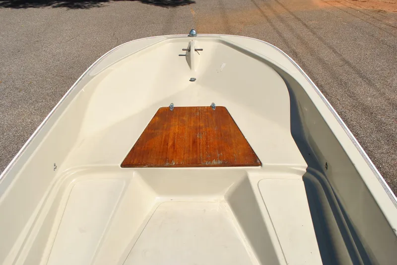 Slide: The Image of 1976 Boston Whaler 15 boat interior with wooden deck, viewed from the bow. - 9