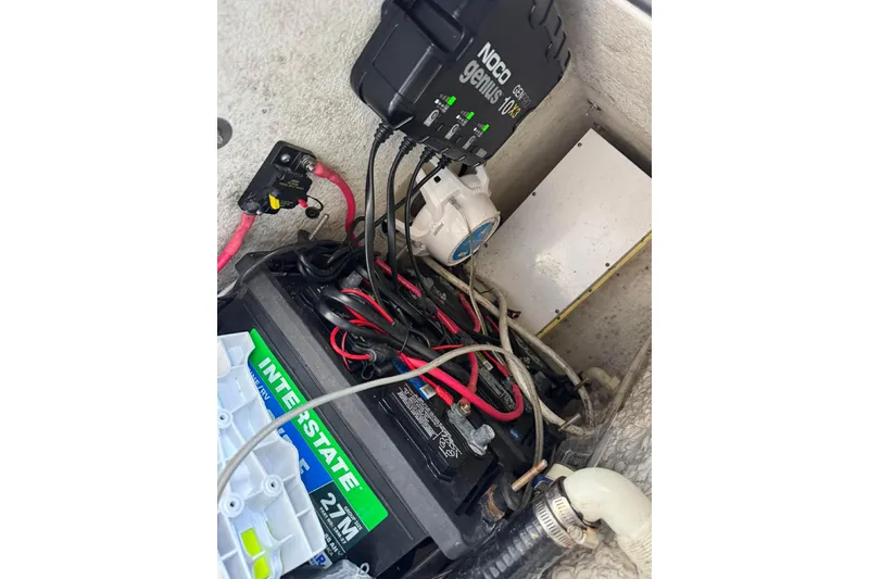Slide: The Image of Battery compartment of a 2020 Sea Hunt Gamefish 27 with wiring and charger. - 10
