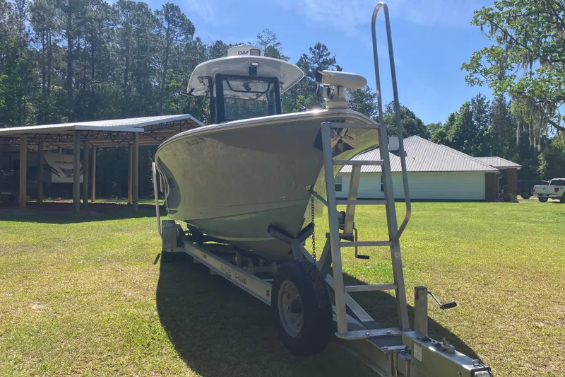 Slide: The Image of 2020 Sea Hunt Gamefish 27 Forward Seating boat interior with storage compartment open. - 21