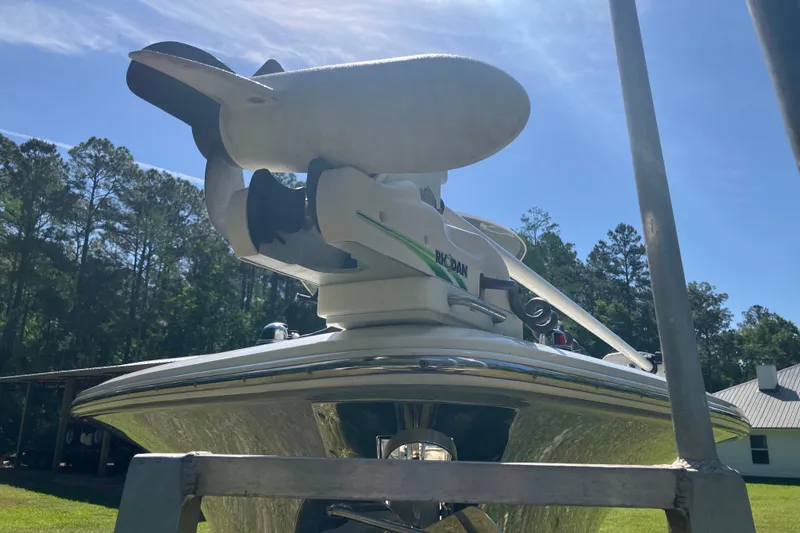 Slide: The Image of 2020 Sea Hunt Gamefish 27 boat with forward seating, featuring a trolling motor, under a clear sky. - 24