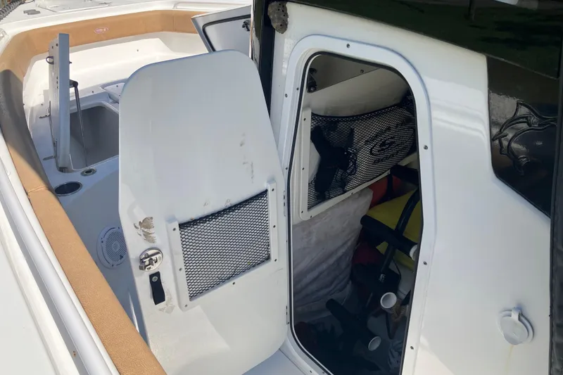 Slide: The Image of 2020 Sea Hunt Gamefish 27 Forward Seating boat interior with storage compartment open. - 42