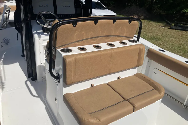 Slide: The Image of 2020 Sea Hunt Gamefish 27 boat interior with tan seating and Garmin displays. - 52