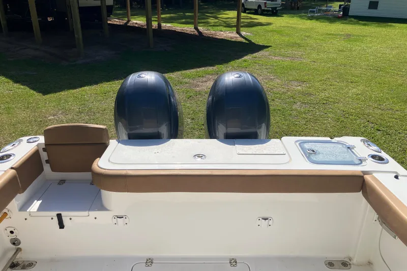 Slide: The Image of 2020 Sea Hunt Gamefish 27 boat with dual engines and forward seating, parked on grass. - 54