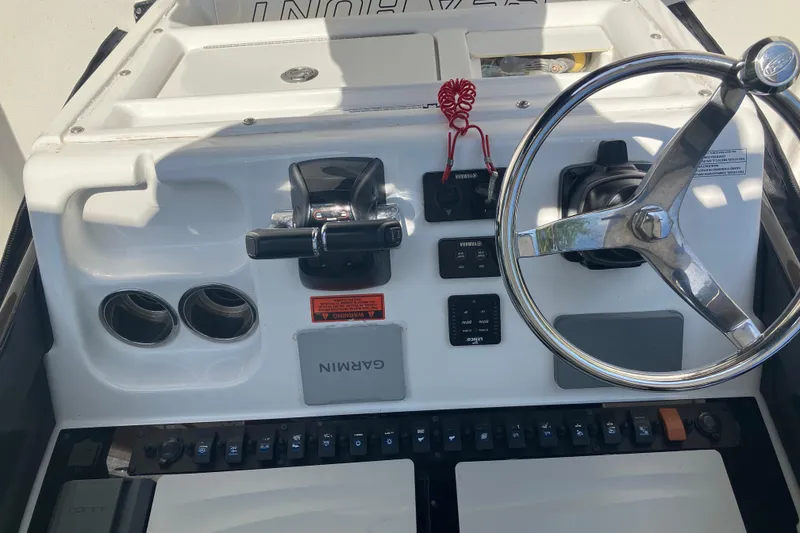 Slide: The Image of 2020 Sea Hunt Gamefish 27 boat dashboard with steering wheel and Garmin navigation system. - 57
