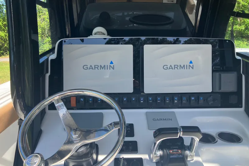 Slide: The Image of 2020 Sea Hunt Gamefish 27 helm with dual Garmin displays and steering wheel. - 60