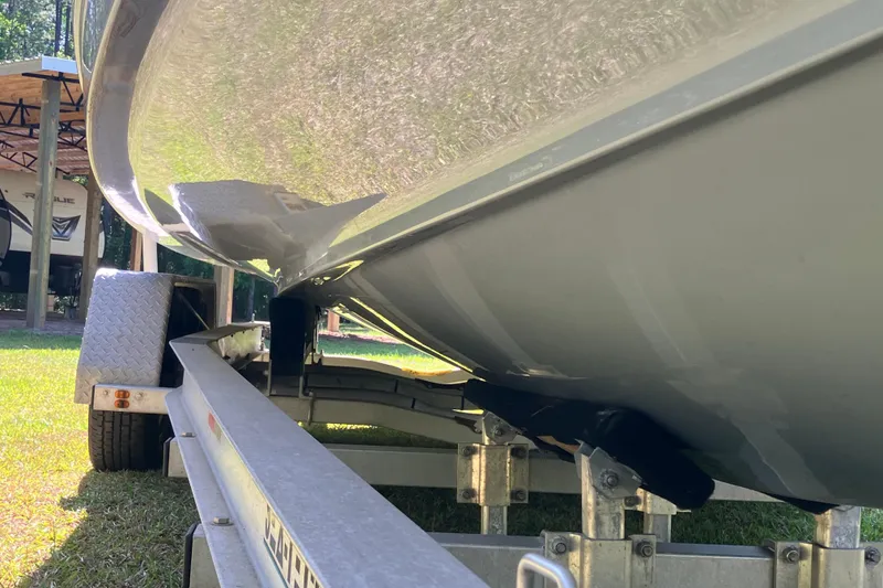 Slide: The Image of 2020 Sea Hunt Gamefish 27 boat on trailer, showcasing hull and trailer details. - 82