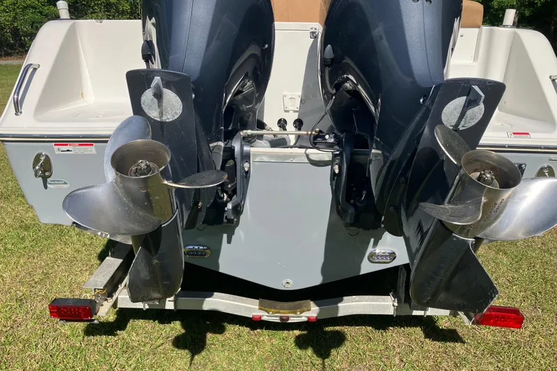 Slide: The Image of 2020 Sea Hunt Gamefish 27 boat with dual outboard motors on a trailer. - 89