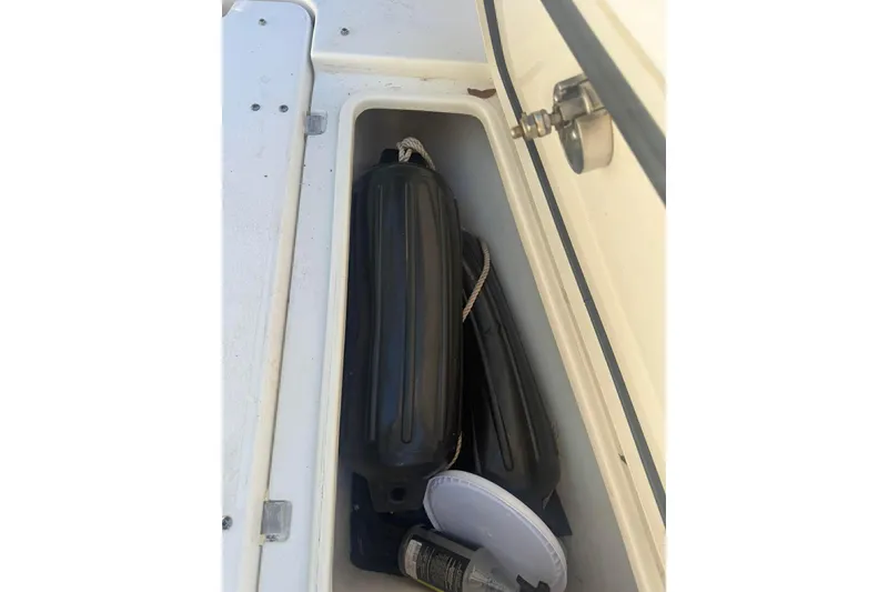 Slide: The Image of Storage compartment on a 2020 Sea Hunt Gamefish 27 boat with fenders and accessories. - 9