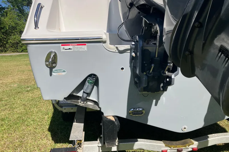 Slide: The Image of 2020 Sea Hunt Gamefish 27 boat stern with motor mount and trailer. - 90