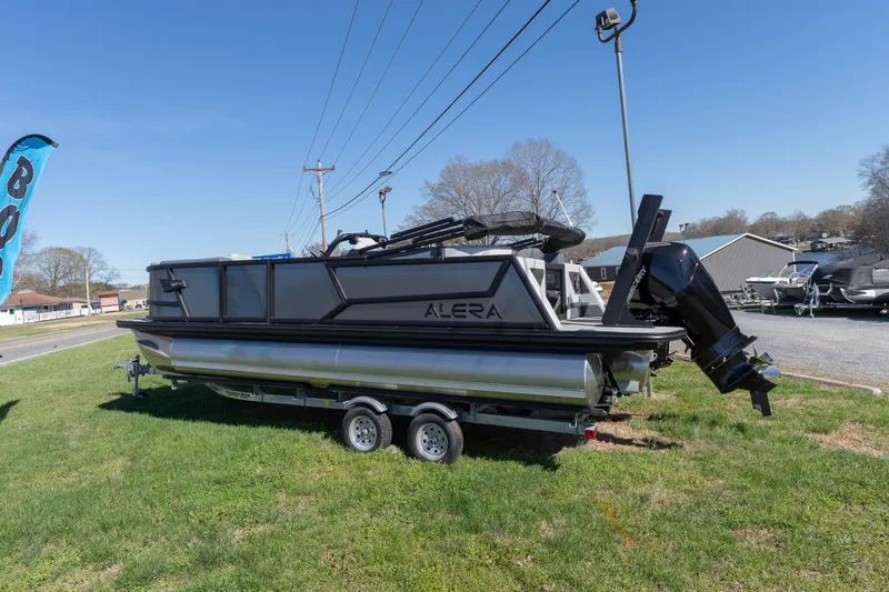 The Image of 2026 Alera M23Q pontoon boat on trailer, displayed outdoors under clear blue sky. - 0