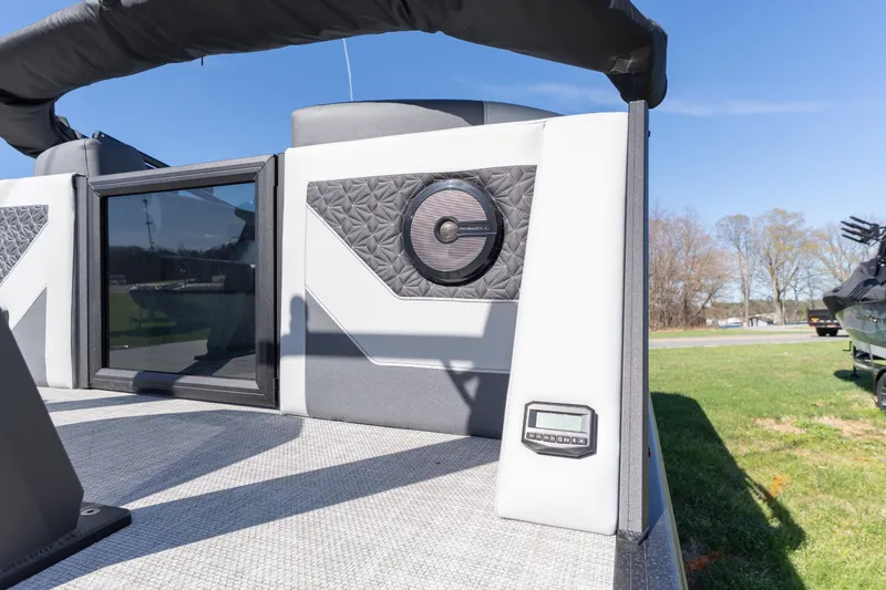 Slide: The Image of 2026 Alera M23Q boat interior with speaker and control panel, under clear blue sky. - 17